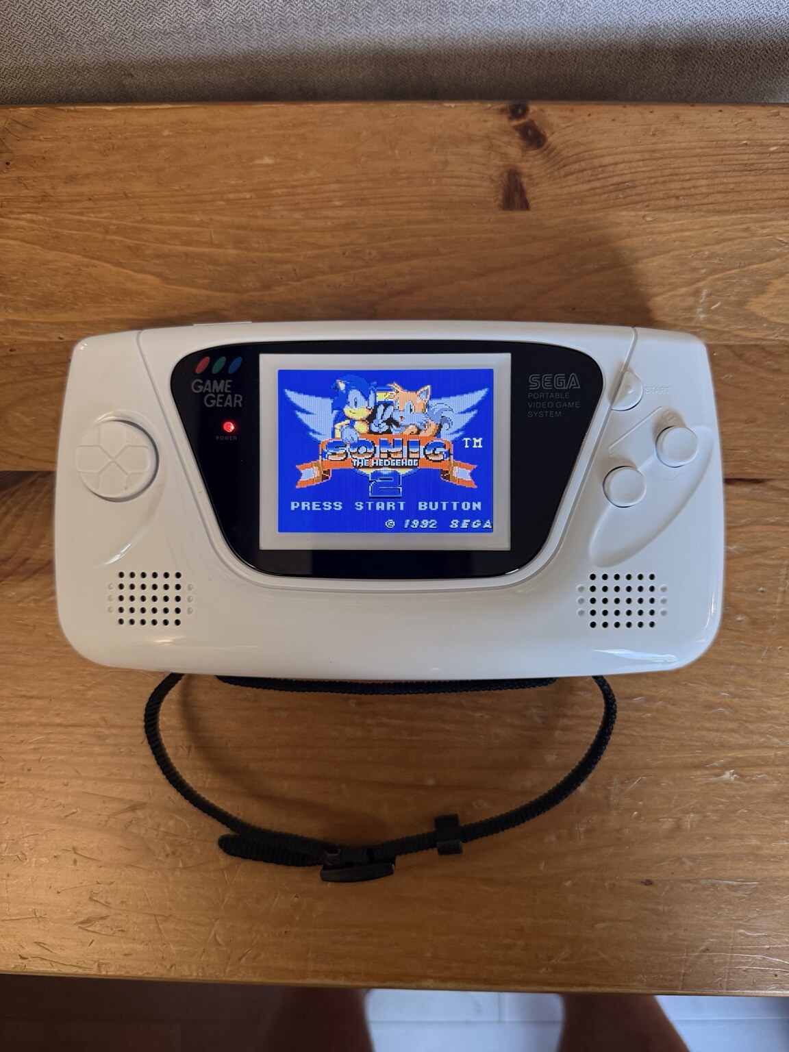 Completed white Sega Game Gear re-shell with an upgraded LCD displaying Sonic the Hedgehog 2